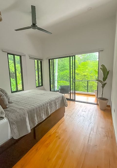 Serene Bedroom: Wake up to lush jungle views and unwind on your private balcony!