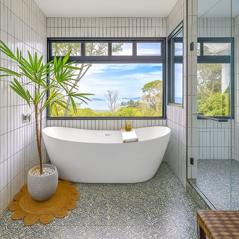 Bathroom Oasis: Enjoy stunning ocean views while soaking in this modern freestanding tub!