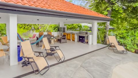 Outdoor Oasis: Indulge in tropical breezes by the shimmering pool with a sleek lounge area!