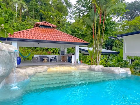 Outdoor Oasis: Indulge in tropical breezes by the shimmering pool with a sleek lounge area!