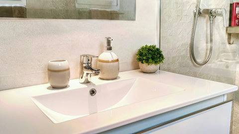 Sleek, spa-like bath with modern vanity and walk-in shower.