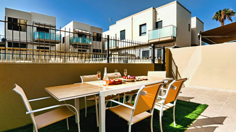 Sunny walled patio with dining for six—perfect for alfresco meals.