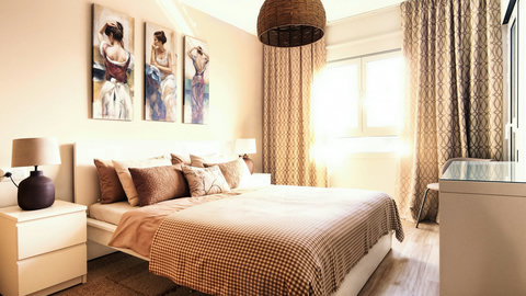 Sunlit, cozy bedroom with queen bed, chic decor and ample storage.