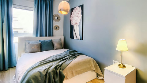 Serene, boutique-style bedroom with cozy double bed and soft lighting.