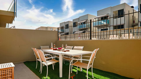 Sunny private patio with dining for six—perfect for al fresco meals