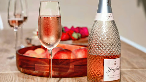 Sip chilled rosé with fresh fruit—romantic dining set on arrival.