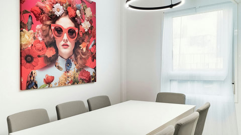 Bright, modern dining with sleek ring light and bold wall art.