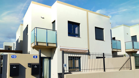 Modern townhouse with balconies, gated entry and private patio