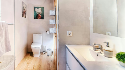 Bright, modern bath with walk-in shower and sleek vanity accents