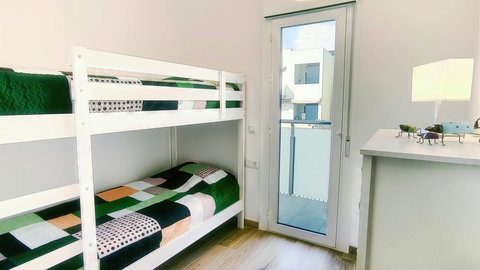 Bright bunk room with balcony access—ideal for kids or friends