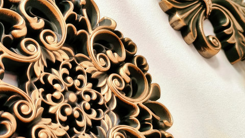 Ornate bronze wall art adds luxury and character to the space