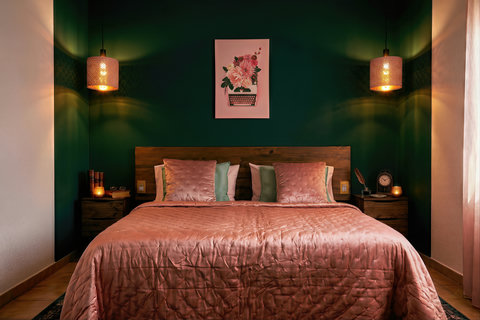 Moody bedroom with pendant lights, plush king bed & warm ambiance