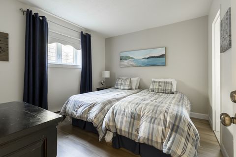 2nd bedroom with a cozy interior and twin size beds.