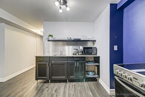 Fully furnished kitchen with basic cooking appliances like microwave, electric kettle, stove etc