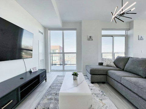 Contemporary living space with sleek finishes, a comfortable sofa, and large windows filling the room with natural light
