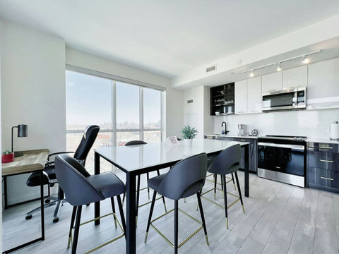Open dining area featuring a sleek design and city views.