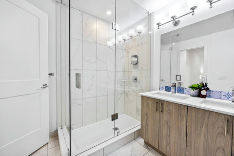 Bright bathroom featuring a shower and spacious vanity