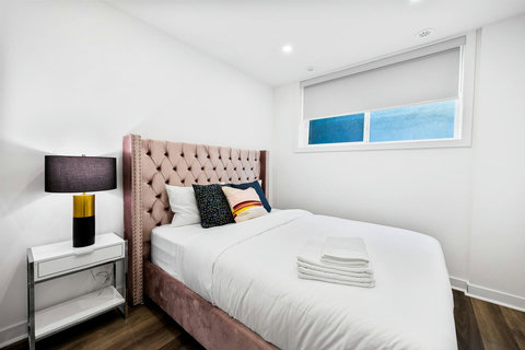 Comfortable bedroom with plush bedding and warm accent decor