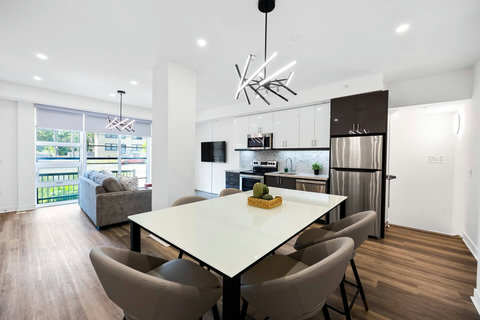 Open dining area with sleek kitchen and stylish living space.