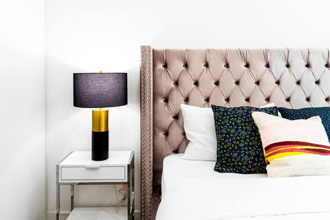 Spacious bedroom with natural light and modern design.