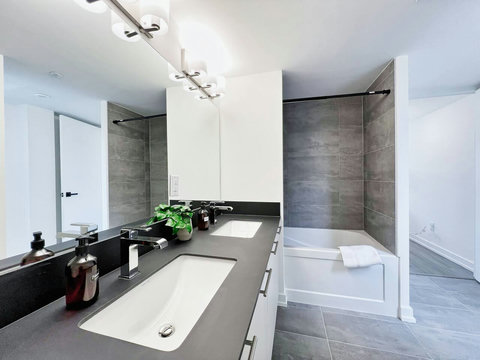 ell-appointed bathroom with a bathtub and glass shelving for easy access to necessities