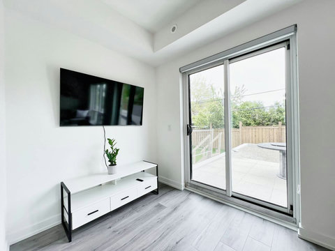 Wall-mounted TV with a sleek shelf and a clear view of the outdoors.