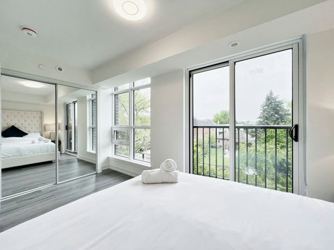 Clean, modern bedroom enhanced by a stylish lighted towel shelf.
