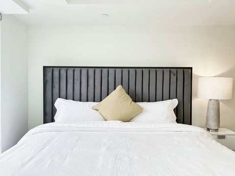 Cozy, organized bedroom with a lighted towel shelf and all the essentials