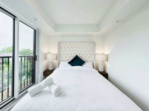 Bright and tidy bedroom complete with a convenient illuminated towel shelf
