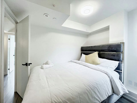 Inviting bedroom space designed with a lighted towel shelf for easy access