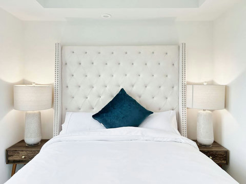 Comfort-focused bedroom setup with soft lighting and a well-stocked towel shelf