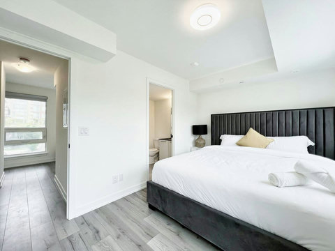 Cozy, organized bedroom with a lighted towel shelf and all the essentials