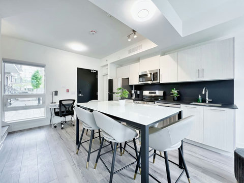 Dine in style with a view in this modern kitchen and dining area - the best spot to enjoy delicious meals while taking in the beauty of the outdoors