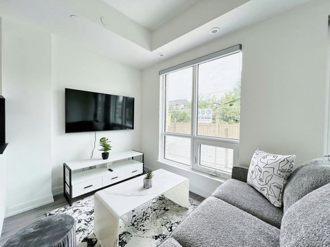 Wall-mounted TV with a sleek shelf and a clear view of the outdoors.