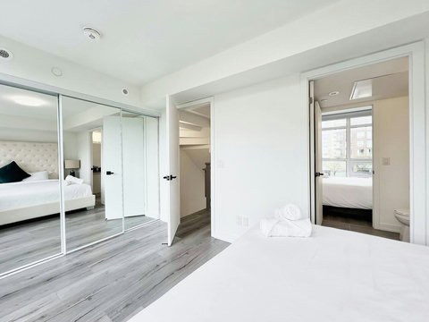 Clean, modern bedroom enhanced by a stylish lighted towel shelf.