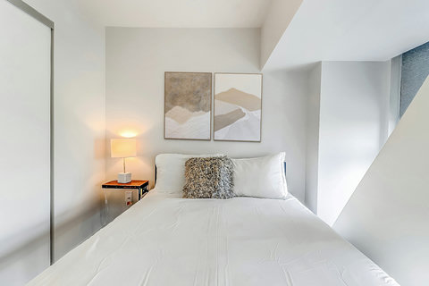 Spacious bedroom with premium bedding and natural light