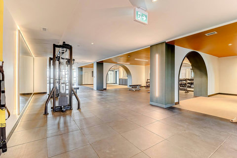“Bright workout area with AC, mirrors, and a motivating atmosphere.