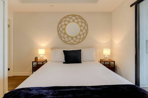 Inviting queen bedroom with soft bedding and a relaxing atmosphere.”