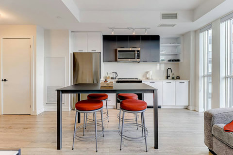 Bright dining area with a modern table setting, cozy lighting, and space for family meals or friendly gatherings—ideal for sharing moments over coffee or dinner.