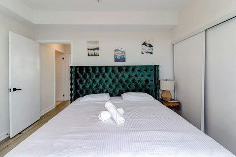 Elegant bedroom with a premium king bed, warm lighting, and modern finishes—designed for ultimate comfort and relaxation.