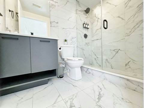 Bright full bathroom featuring a sleek vanity, spacious shower, and premium essentials—designed for comfort and relaxation.