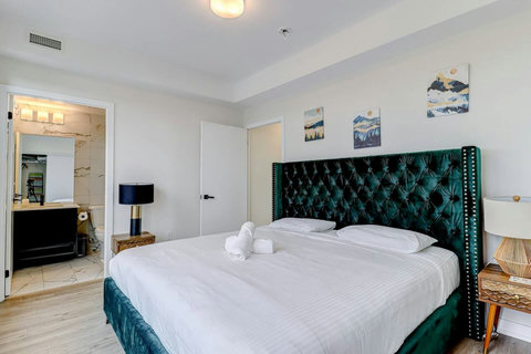 Elegant bedroom with a premium king bed, warm lighting, and modern finishes—designed for ultimate comfort and relaxation.