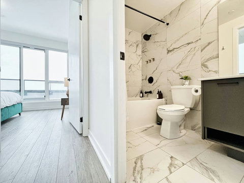 Elegant bathroom with modern fixtures, a bathtub, and fresh towels—perfect for a spa-like experience at home.