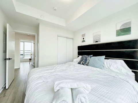 Bright and cozy bedroom featuring a comfortable king bed, fresh linens, and a peaceful ambiance for deep relaxation.