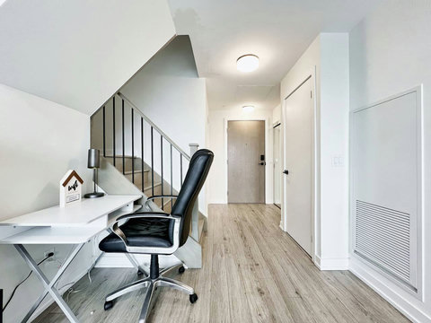 Bright and focused workspace with a comfortable desk and chair — perfect for remote work, study, or creative projects during your stay.