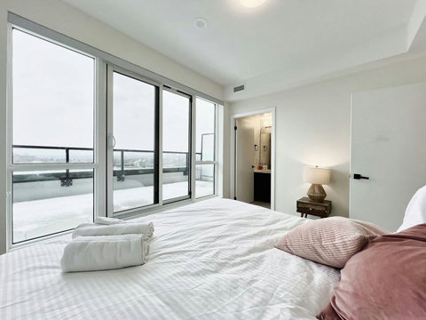 Elegant bedroom with a premium king bed, warm lighting, and modern finishes—designed for ultimate comfort and relaxation.