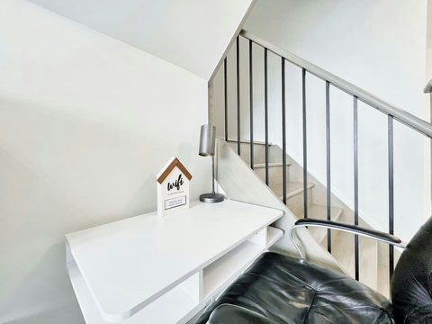 Bright and focused workspace with a comfortable desk and chair — perfect for remote work, study, or creative projects during your stay.