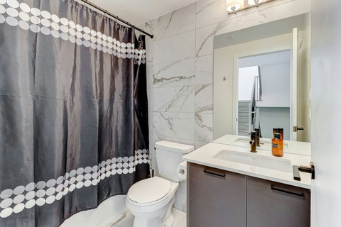 Elegant bathroom with modern fixtures, a bathtub, and fresh towels—perfect for a spa-like experience at home.