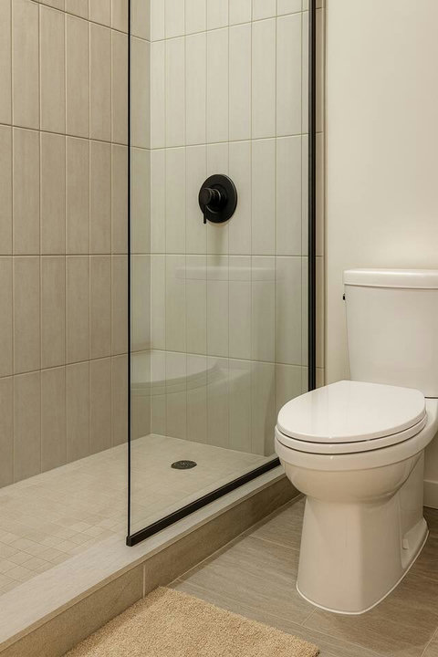 Spotless, modern bathroom with fresh towels and essentials.”