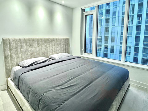 Inviting king bedroom with soft bedding and a relaxing atmosphere.”